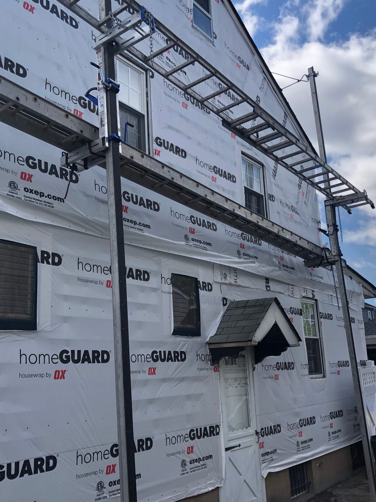 Exterior remodeling with house wrap and scaffolding on a New Jersey home, Bergen County NJ by NJ Vinyl Siding