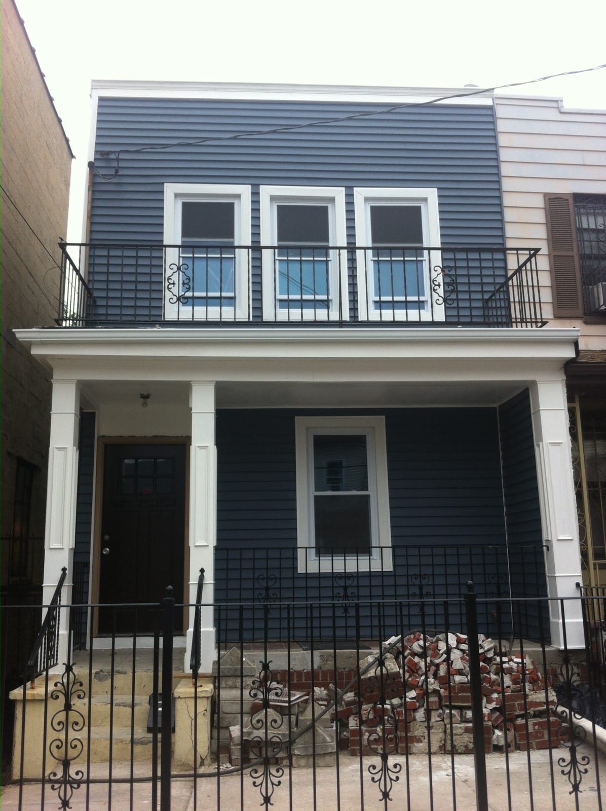 Exterior siding, custom trim work aluminum fascia, pvc trim and front porch remodeling project in Jersey City, Hudson County