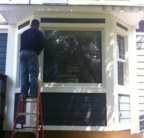 White Azek trim installation on a dark gray bay window, North and Central New Jersey