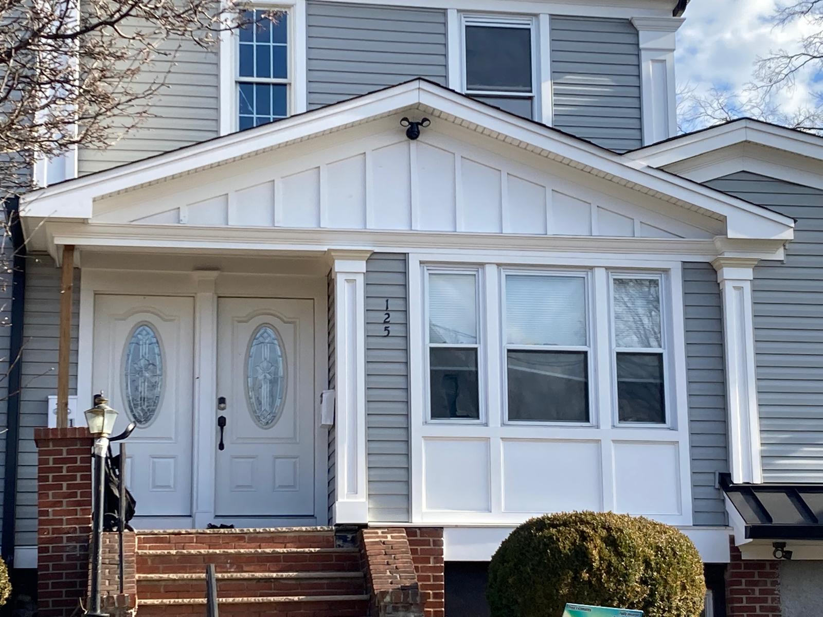 New Jersey home exterior with new vinyl siding and coordinated roofline