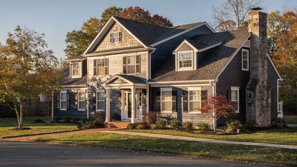 Monmouth County home with navy lap siding and grey shake gable accents exposed to coastal wind